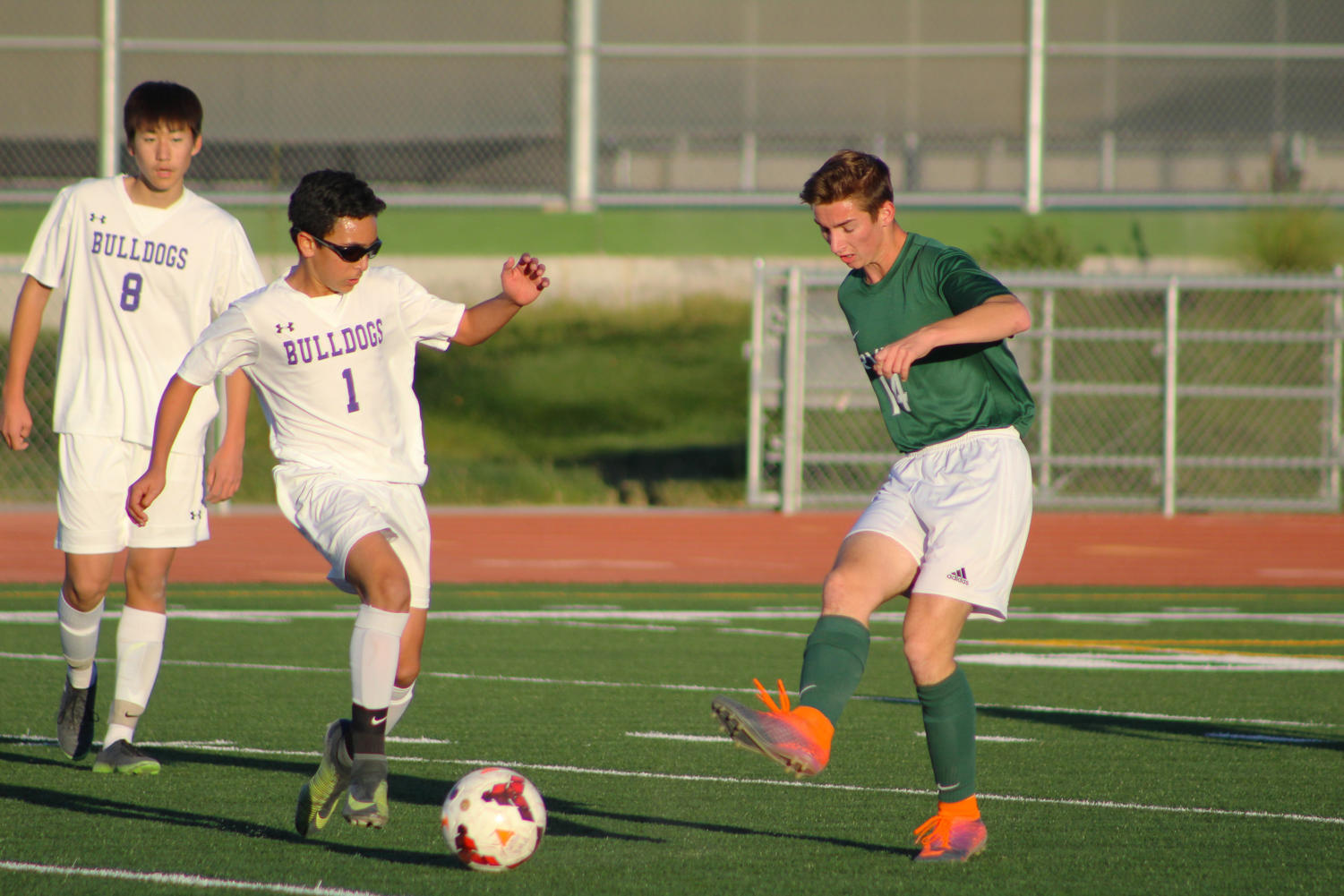 Sophomore and center mid Mustafa Hassan works around opposing players to keep the ball in his possession and passes to his teammates.