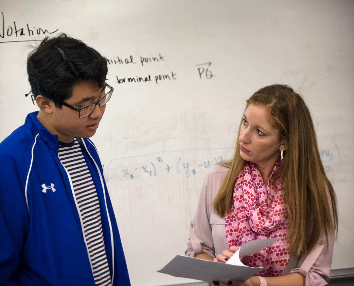Continuing her teaching in Office Hours, Shelley Godett explains the answers to homework questions with sophomore Joshua Kwon.