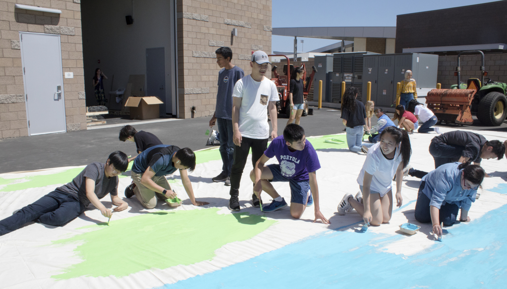 The technical theater crew paints a backdrop for the upcoming “Wizard of Oz” musical, utilizing the color wheel and brush strokes to create a realistic, whimsical set.