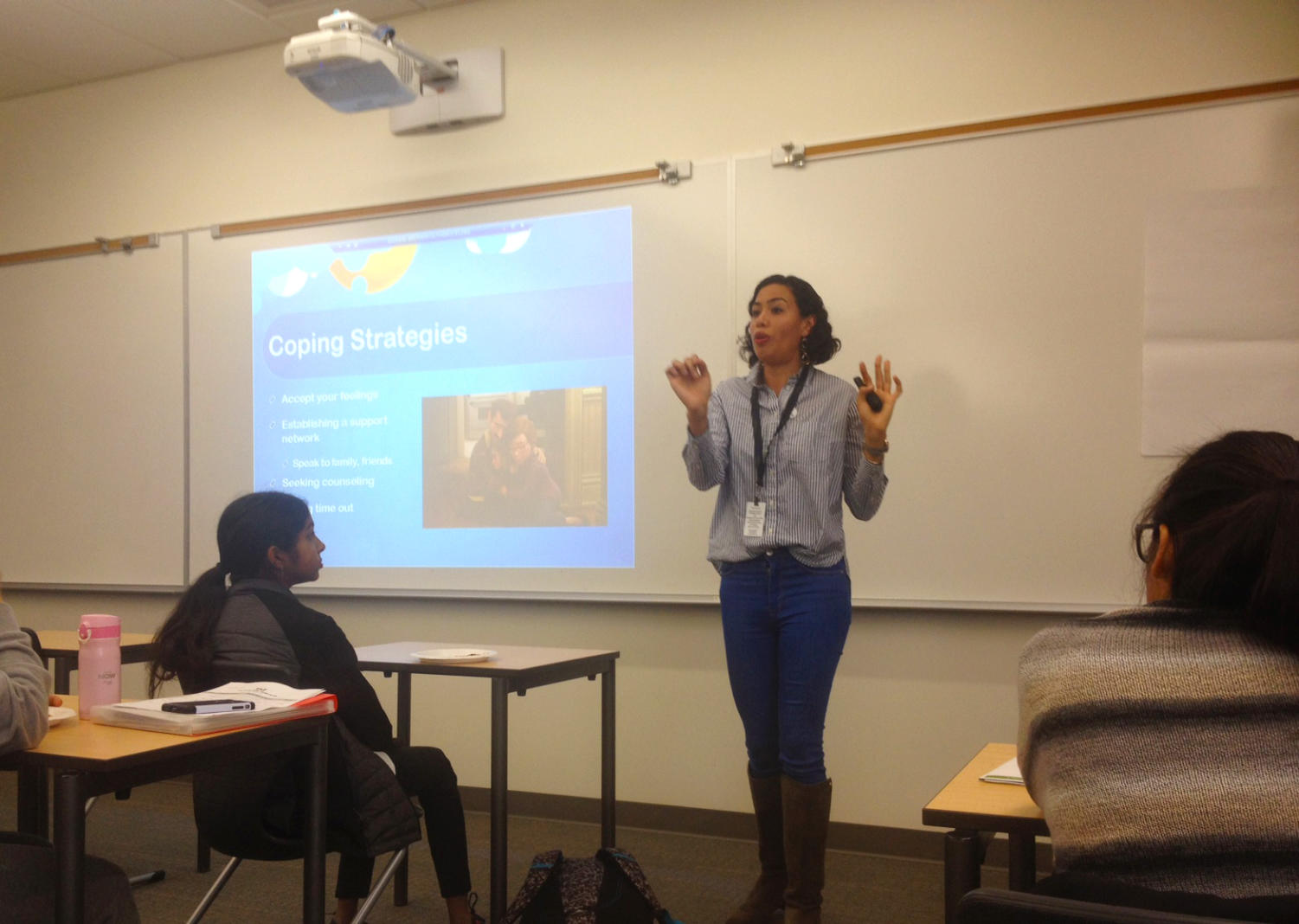Speaker Stephanie Zapata encourages students in the audience to discover their healthy coping methods by sharing her own high school experiences with self-care.