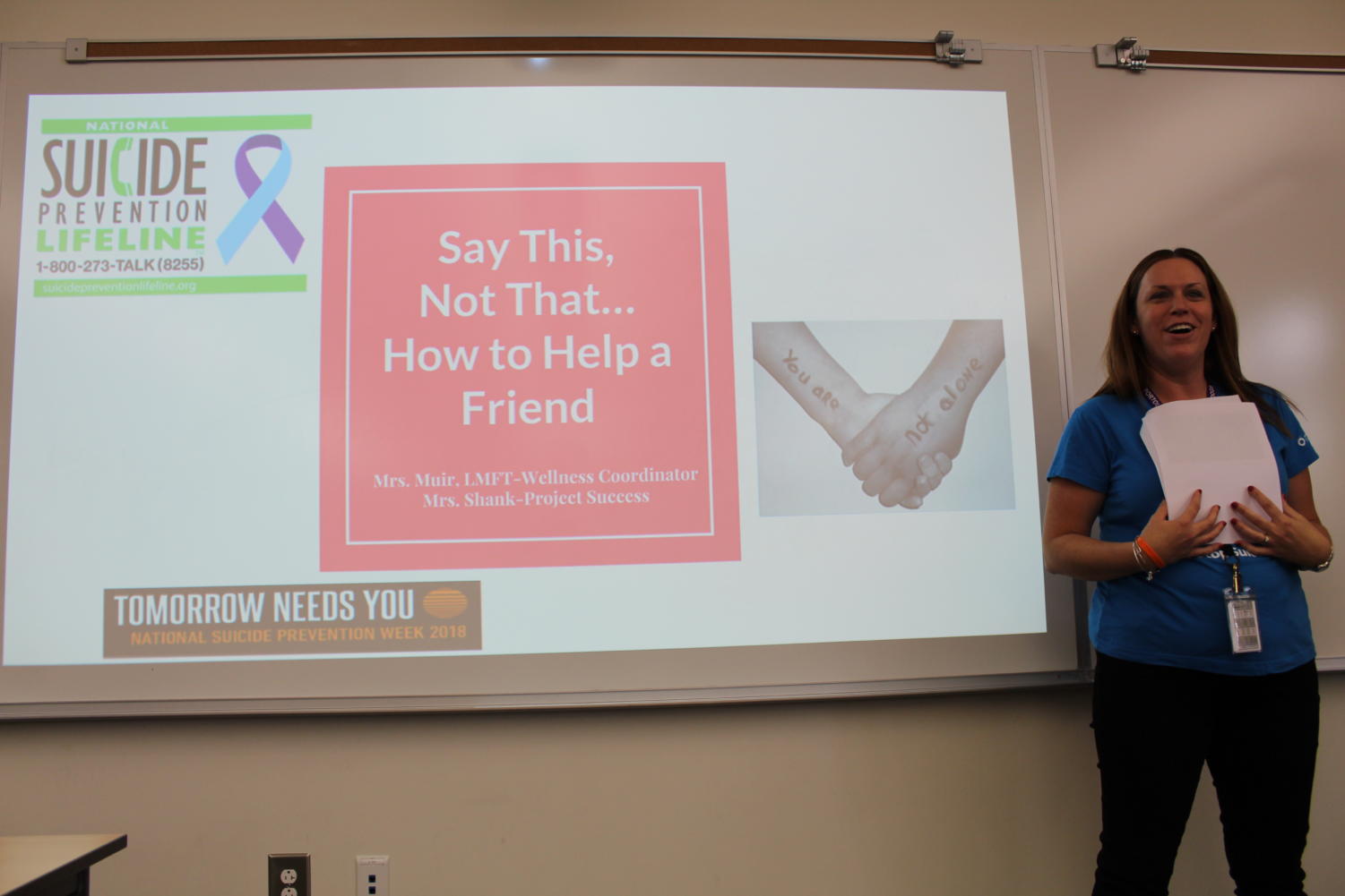 Wellness coordinator Maureen Muir notices a counselor videotaping before she begins the presentation outlining phrases to say to a struggling peer.