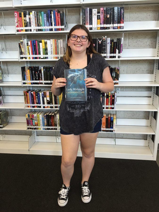 Freshman Piper Porter checked out the first book from the Learning Commons.