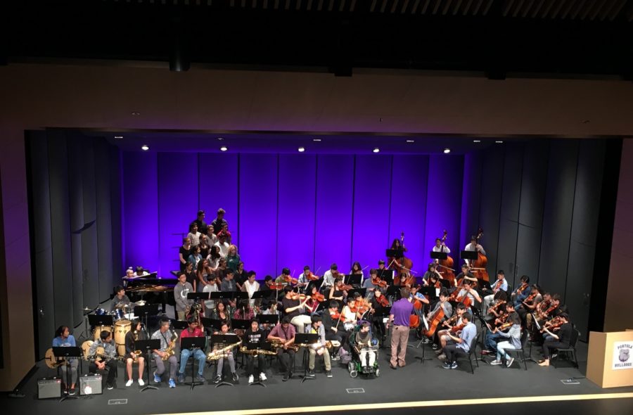 Mr.+Stevens+conducts+his+String+Orchestra+as+they+perform+at+the+Fine+Arts+Assembly.