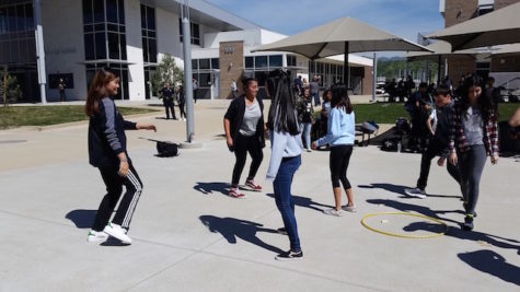Students join together during intercultural week to play seven stones.