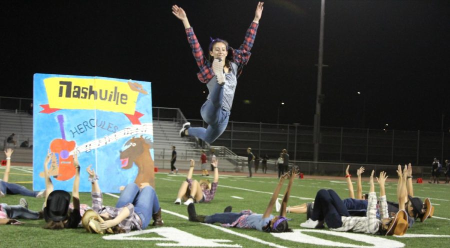 Freshman Ashley Presnell leaps in the air into a perfect split during Hercules segment in the halftime show.