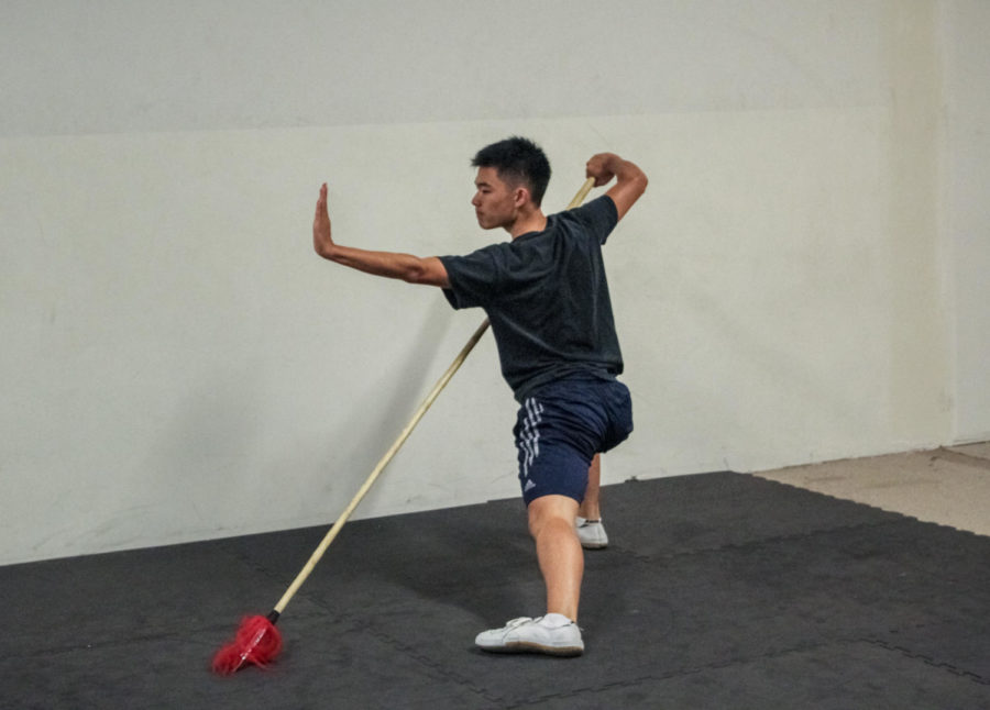 Ethan Niu trains with a spear during his routine for wushu competitions. 