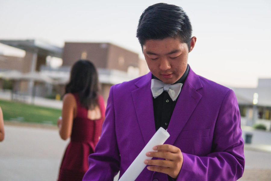 Hercules house president Anthony Lu checks the foam glow stick lights before the Forthcoming dance. 