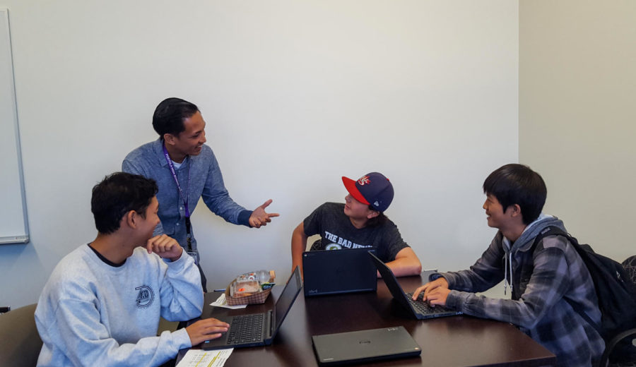 Ryan Itchon talks with students Brennan Sasaki, Tyler Sylvester, and Brendan Sung about Naviance. 