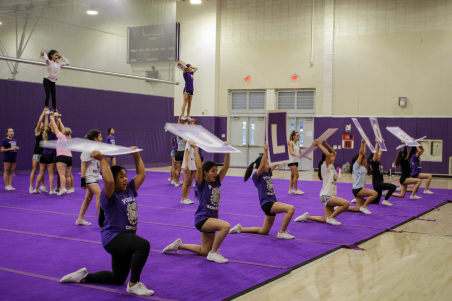 Cheer+squad+practices+a+new+routine+for+its+upcoming+performances.