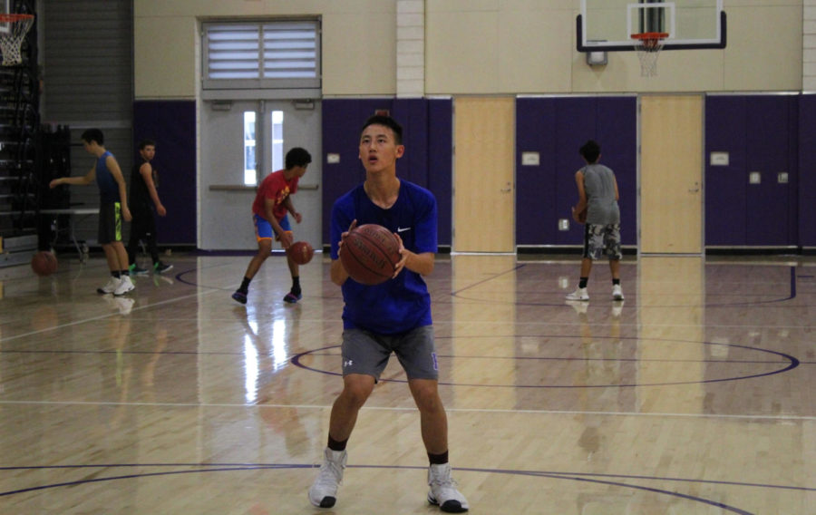 Sophomore Jeffrey Chen attempts to make a basket during a drill at practice.