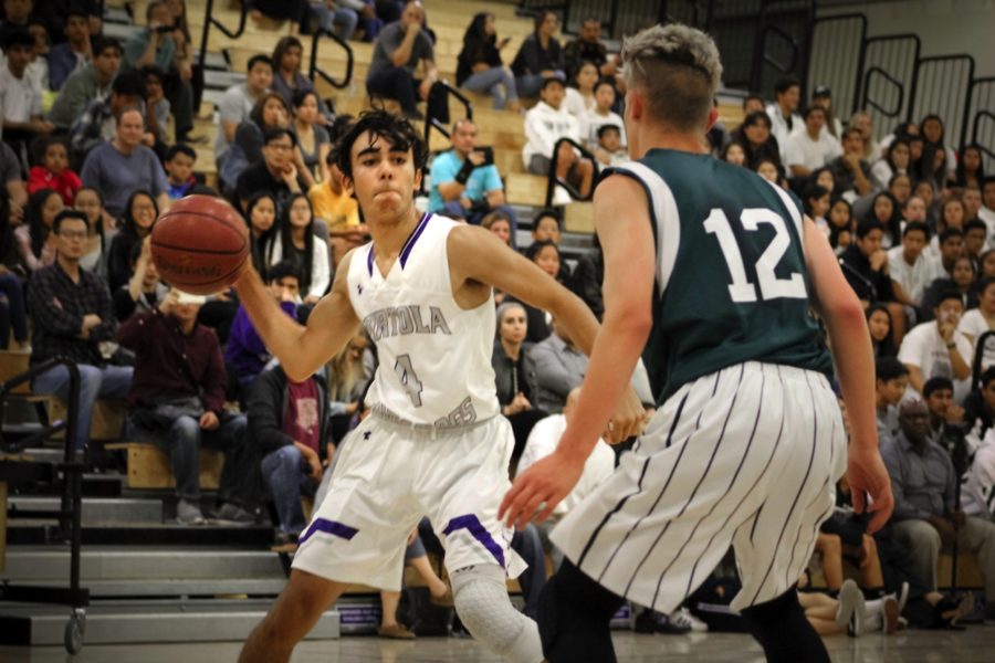 Sophomore and shooting guard #4 Omar Habibeh attempts to work around a defensive Pakuranga player in order to pass the ball to a teammate.
