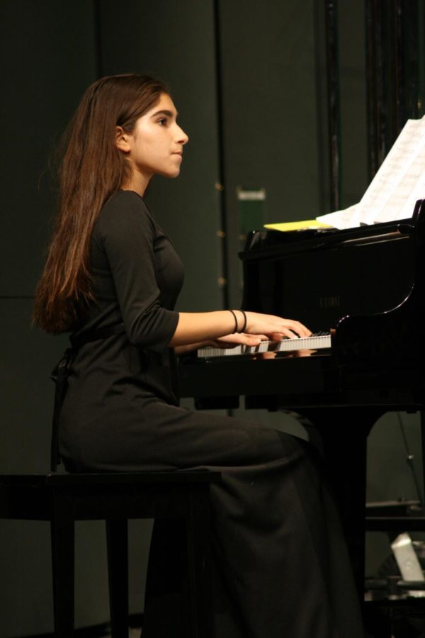 Saba Najafi performs “Mad Russian Christmas” on the piano during the second night of the winter concert. 