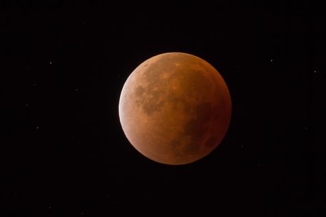 In addition to the red tint of the moon caused by the lunar eclipse, the elliptical orbit of the supermoon allows it to appear 14 percent larger and up to 30 percent brighter.