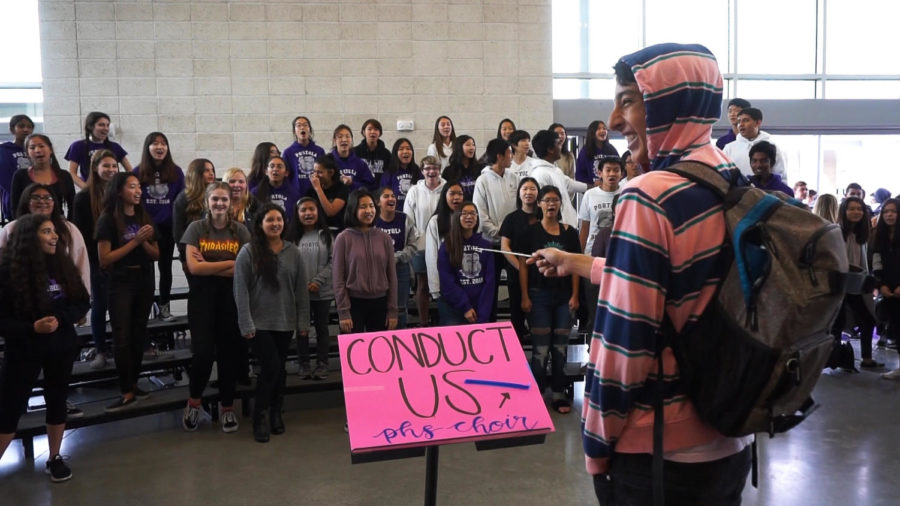 Sophomore Roham Ghiasi radiates pure joy as he conducts the choir during the lunchtime activity. 