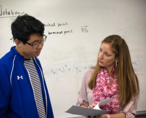 Continuing her teaching in Office Hours, Shelley Godett explains the answers to homework questions with sophomore Joshua Kwon. 