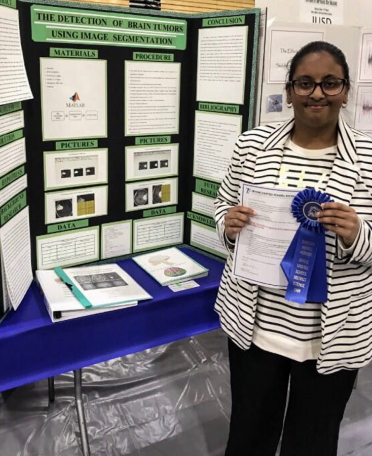 During the Science Fair, Aamina shows her project to the audience. She explains how her project breaks down the image of a brain tumor into parts that are easy to read.