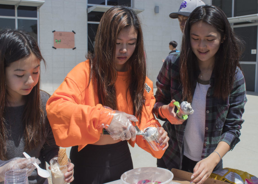 Club+members+and+sophomores+Annika+Lai%2C+Miranda+Wang+and+Lauren+Hwang+scoop+out+ice+cream+and+churros+in+return+for+tickets+for+Create+the+Change+Club.+Hwang+founded+the+club+in+order+to+help+families+in+Peru%2C+and+plans+on+using+the+money+earned+from+Club-a-Palooza+to+purchase+lotions%2C+vitamins+and+other+materials+to+help+the+children+in+need.