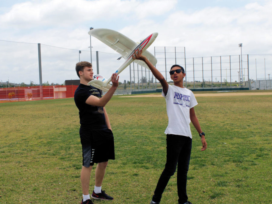 Mike+Nassif+shows+Nick+Medvedev+how+to+launch+a+remote+controlled+airplane.