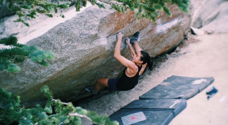 Sophomore Phoebe Yun practices bouldering, a type of climbing that requires immense physical strength to complete a routine on a boulder close to the ground without any harnesses or ropes