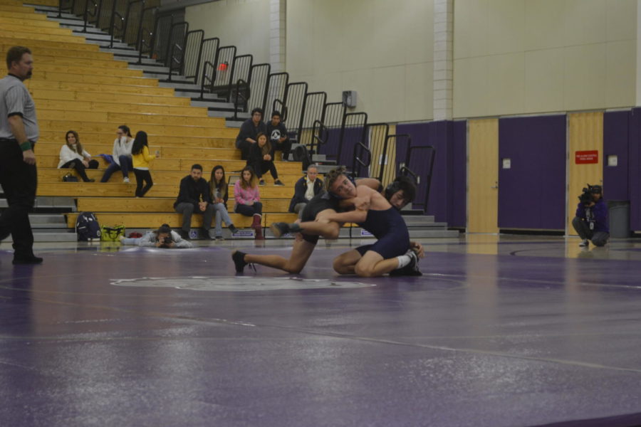 Sophomore+Jackson+Cooper+performs+a+sprawl+on+his+opponent+in+an+effort+to+take+him+down.