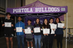 Winter Top Dog award recipients lined up after a night of food and speeches in their honor. Athletes include: junior Mohsen Hashemi, junior Anirudh Chaudhary, freshman Ethan Qureshi, junior Alyssa Ing, junior Madelyn Noh, sophomore Kaitlyn Miller and sophomore Adele Yoon.