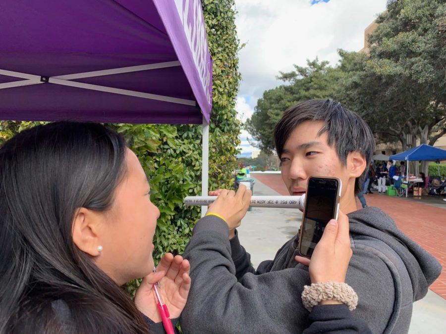 Junior Yunseong Jung tests out the flute that he and partner junior Stephanie Zhang built to compete in the event Sounds of Music. In the event, team members play the twelve tone scale on the flute they constructed, with pitch frequency being tested for accuracy. 