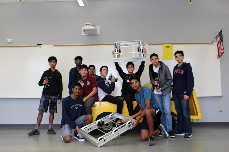 Jonathan Lee, Sarath Suresh, Goshan Kumar, Anthony Chan, Ryan Bascos, Neil Lin, Akshay Raj, Trung Huynh, Joshua Sharma, Goshan Sandal and Brian Chen (left to right) stand with their two robots constructed out of aluminum.  
