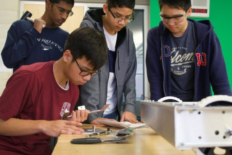 FIRST Robotic Team’s sophomore Trung Huynh builds the structure for the battery compartment, finishing the final parts of the robot’s base, while sophomore Neil Lin and freshmen Goshanraj Sandal and Ryan Bascos prepare for assistance. The robot is designed to secure the most game pieces possible into the rocket ship’s holes in the time slot allowed, in a competition aligned with the ‘Deep Space’ theme.
