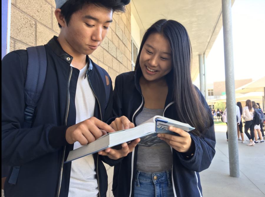 Junior Stephanie Zhang and freshman Ryan Jung, collaborators in developing Portola’s new philosophy class, point out references to philosophical topics in the AP U.S. History textbook. 