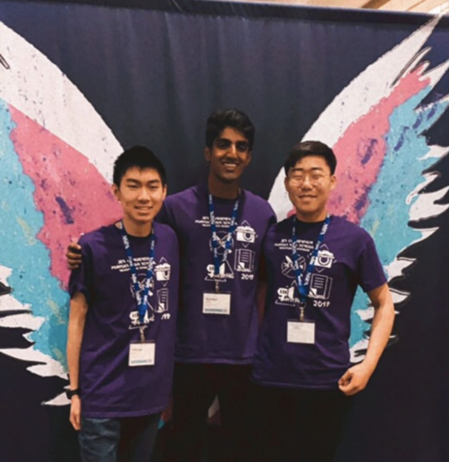 Juniors William Hsieh, Rane, and Ki Joon lee (left to right) pose in front of a painted mural at the convention. 