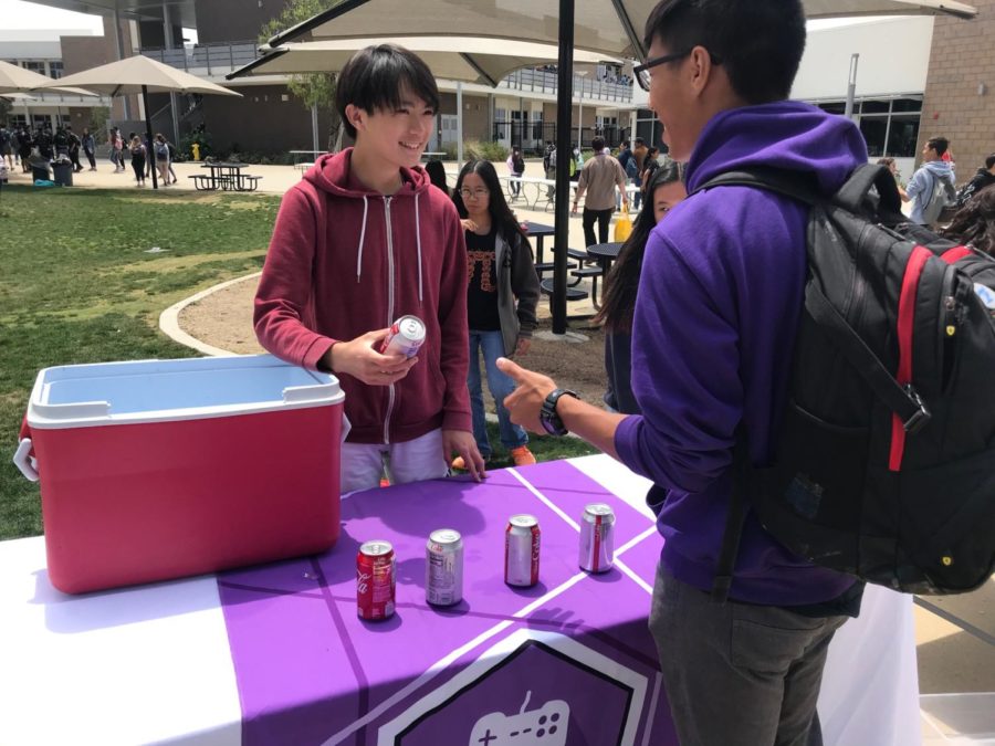 Junior+Aiden+Wu+sells+Coke+to+fundraise+for+the+eSports+club.+Students+purchased+tickets+for+a+dollar+each+to+exchange+for+food+items.