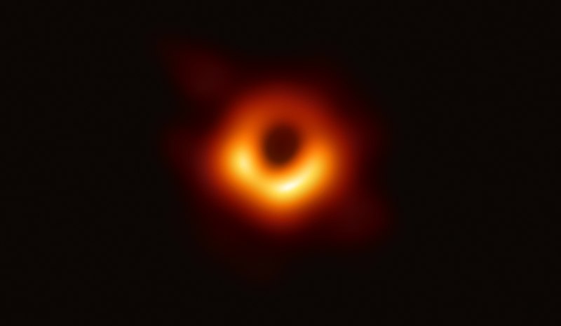Produced by the Event Horizon Telescope on April 10, a golden ring where the event horizon is surrounds the silhouette of a black hole in the center.