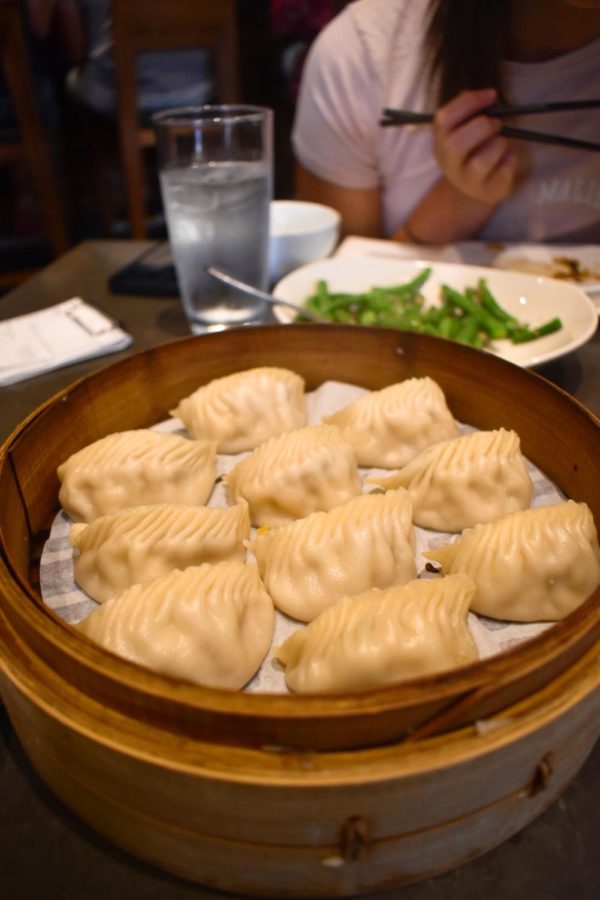The wooden steamer opens like a treasure chest, majestically revealing deliberately arranged chicken dumplings. Despite a robust and welcoming aroma, the taste can be described as average at best.