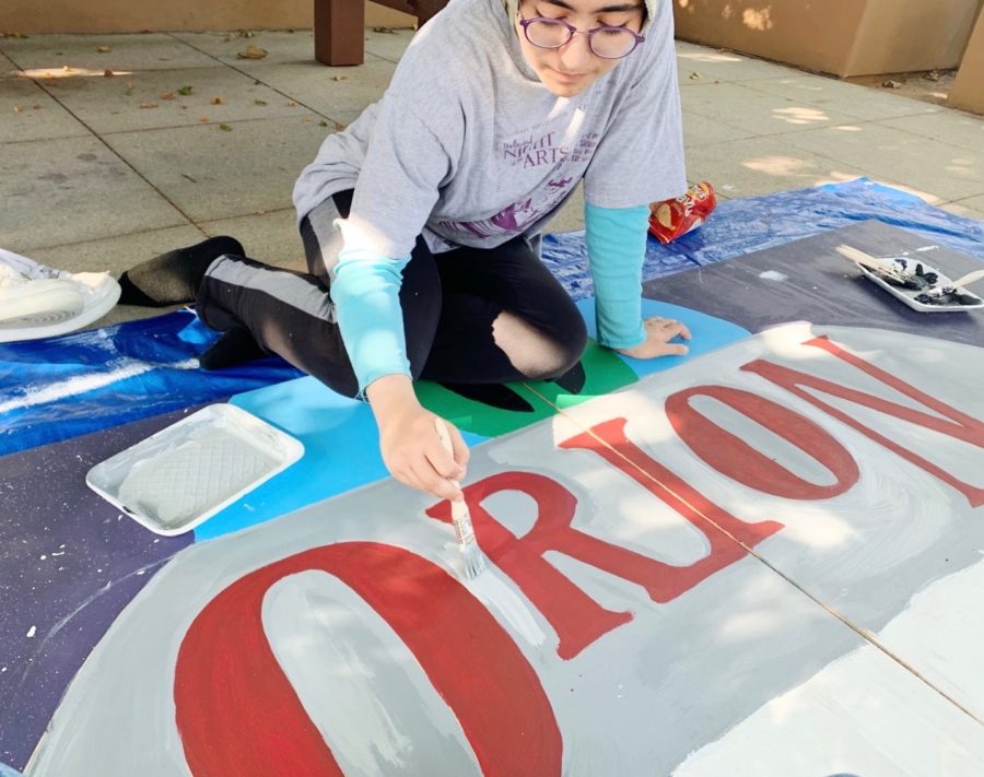 Junior Mona Tavassoli fills in the Orion backdrop. Students from all four houses gathered on Oct. 12 to paint backdrops and rehearse dances for the halftime show. ASB’s efforts were more organized this year because of the increased participation and spirit of the student body.