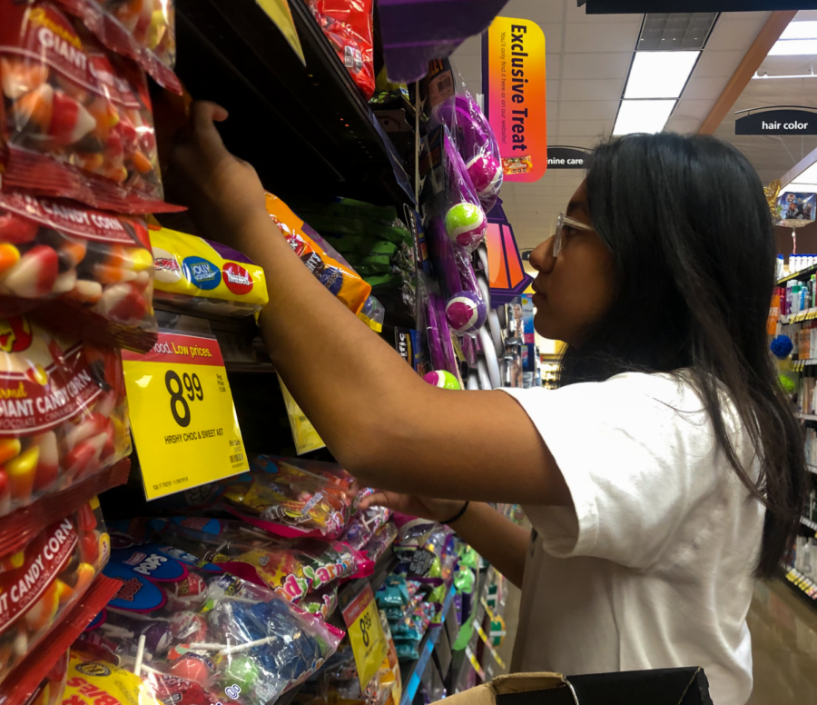 Sophomore Cinta Adhiningrat takes a look at the candy selections in the Halloween candy aisle at a local Ralphs. She mentions that her favorite candy is KitKats while her least favorite candy is Candy Corn. 