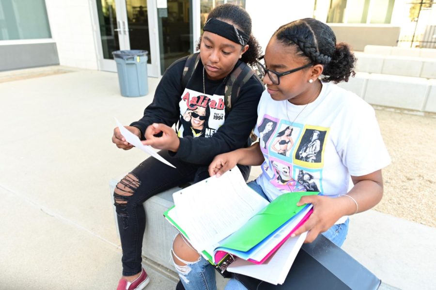 Amari Trevino-Beverly reviews systems of equations with her sister Ailani Beverly before her upcoming math test. Trevino-Beverly tutors her siblings in various subjects and disciplines.