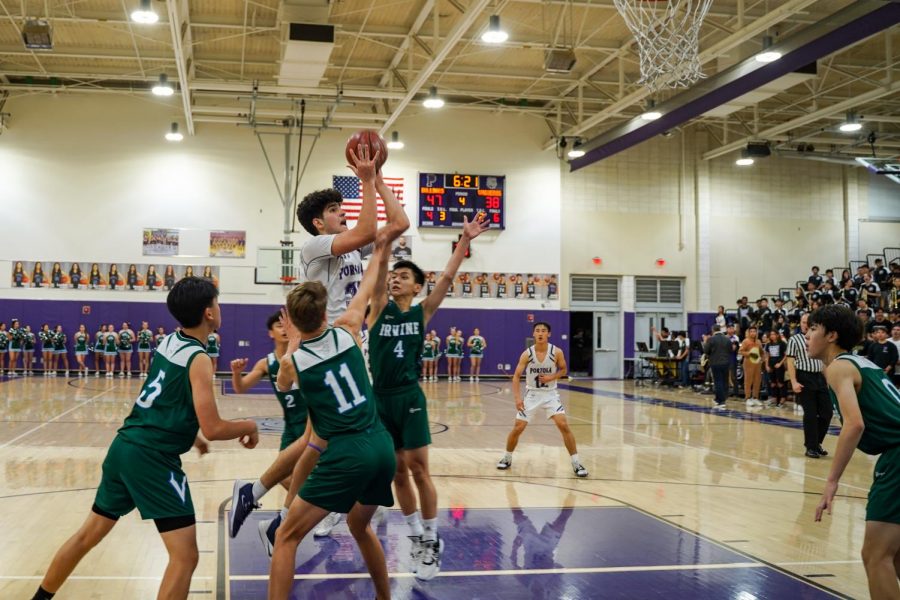 Forward and senior Mohsen Hashemi flies to rim while contested by Irvine High players. Hashemi was the Bulldogs’ leading scorer with 21 points.