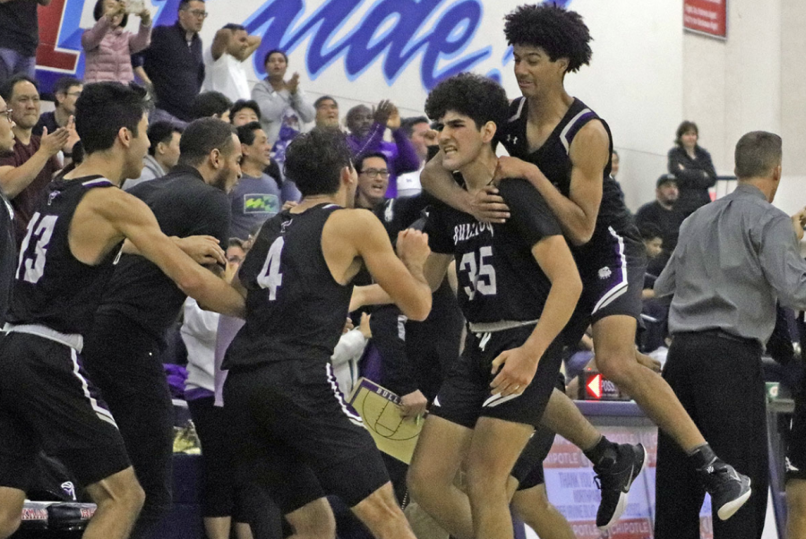 Boys basketball celebrates its league win after senior Mohsen Hasheimi shoots a game-winning shot in the last second of the game. The teammates celebrate their comeback after losing to Beckman 49-60 earlier in the season.