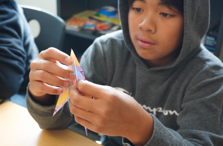 Freshman Caden Wu uses intricate folds and cuts to create a crane out of colored paper. The orizuru, or paper crane, is considered the most classic Japanese origami sculpture and is associated with celebration and hope. 