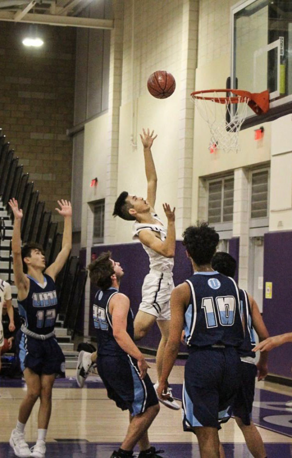 After providing strong defense for the backcourt, Senior Justin Tam steals the ball from University High and rushes to the frontcourt for a swift layup.