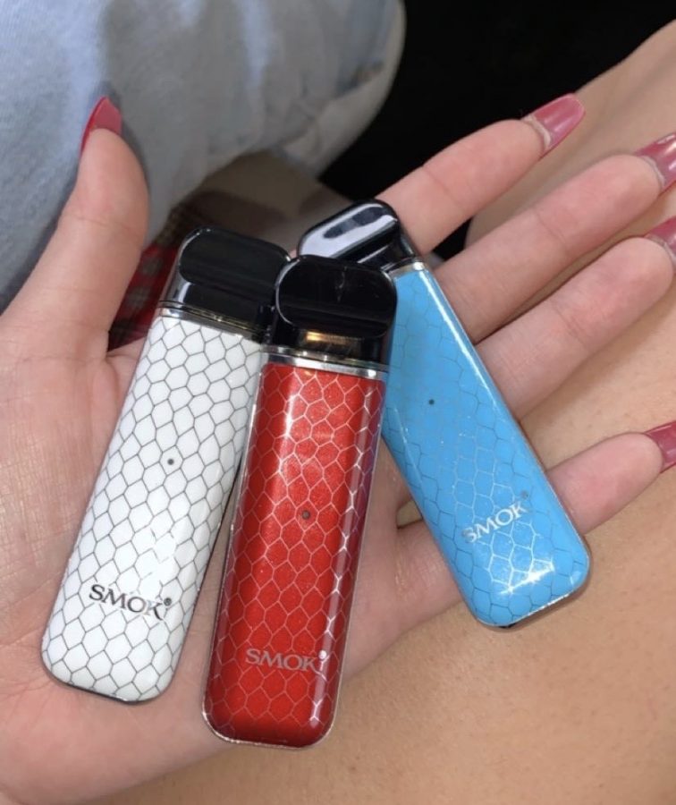 A student displays three Novos (e-cigarettes) which they have come to carry with them almost everywhere they go.