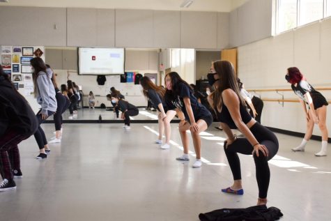 Before reviewing what they learned the previous class, dancers quickly perform a stretch routine along to one or two songs.