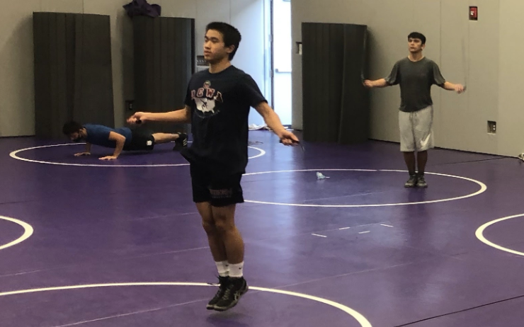 At socially-distanced wrestling practices, very few new freshmen join returning upperclassmen at daily after-school practice. New wrestlers have time to communicate and ask both athletic-and academic-related questions to their team as they wrestle against social distancing guidelines.