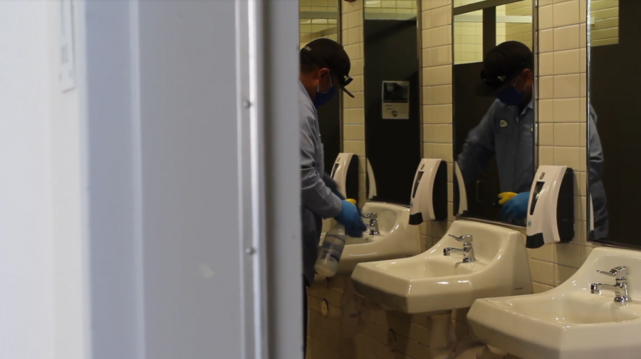 Physical education equipment custodian Noe Belmudez cleans the sinks in one of the restrooms during second period with a special disinfectant. During each period, the custodial staff must clean every restroom on campus, as well as any other area classified as a high touch point.
