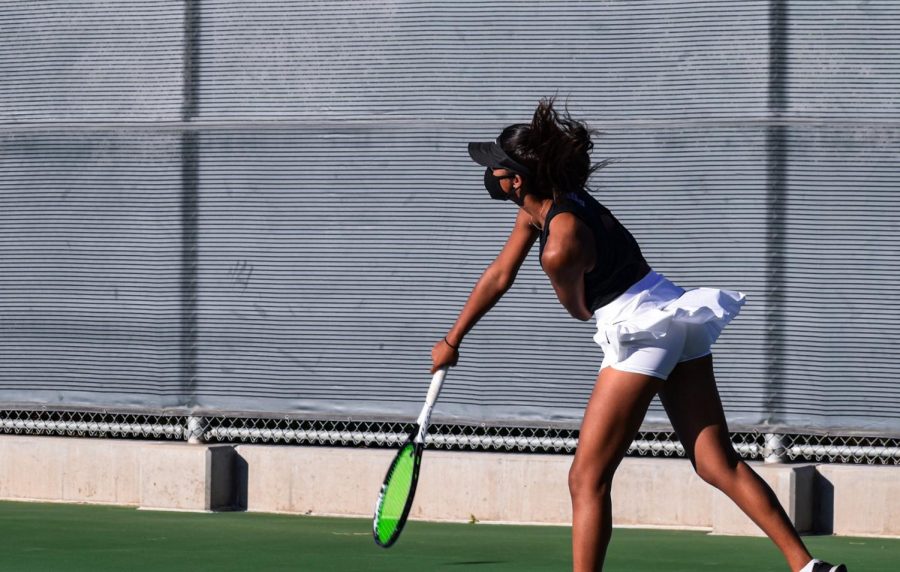 Sophomore Prisha Rapur shifts her weight to her left leg as she extends and rotates her arm to deliver a forehand groundstroke across the court.