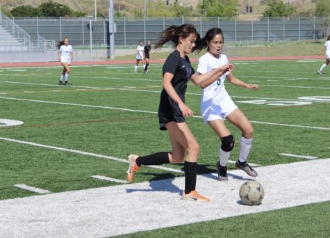 Right forward and junior Krista Calkins uses her body to protect the ball from the Vaqueros’ defender with hopes of finding another forward to drive it up the field. Calkins was substituted in for Song in the last seven minutes of the half. 