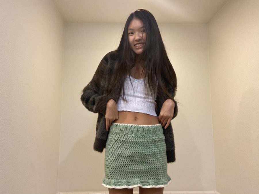 Ngo models her latest crocheted creation, a pale green skirt, which was listed on her Depop for $70. Skirts are by far her most time-consuming pieces, taking around seven hours to complete. “I’m actually backordered a lot,” Ngo said. “I remember one time, I was backordered by seven to 10 orders, so right when I got home from school, I would sit down and just start.”