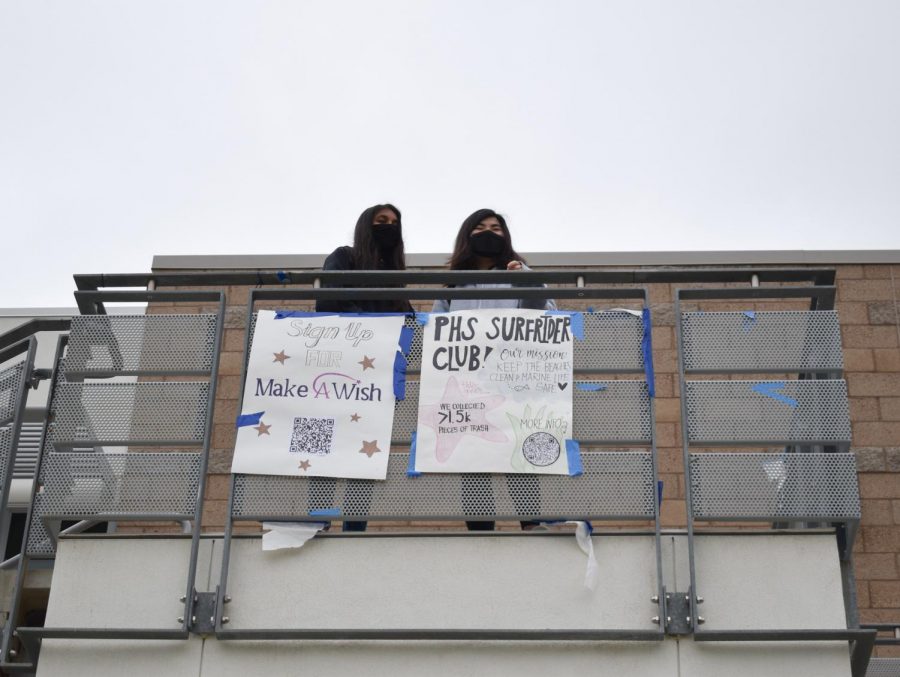 Juniors Sriya Boppana and Jessica Kim participated in Club-a-Palooza by viewing the posters around the school from the 600 building. Pictured below them are club posters for the Make a Wish and PHS Surfrider Clubs, which included QR codes for prospective members to find more information online about how to join. 