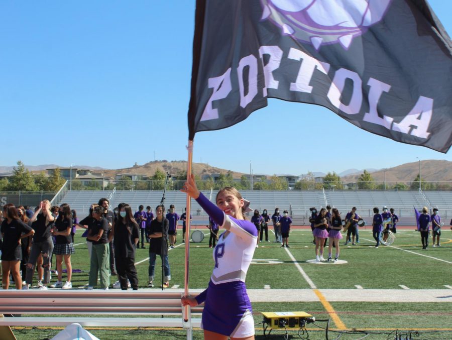 Moll waves a large flag with an image of Buster the Bulldog as students enter the stadium. Behind her, the Pride of Portola, which includes marching band and color guard, have already taken their places on the field. “Getting to play in the marching band and show off to the entire school, it was pretty fun,” clarinetist and freshman Danny Song said.
