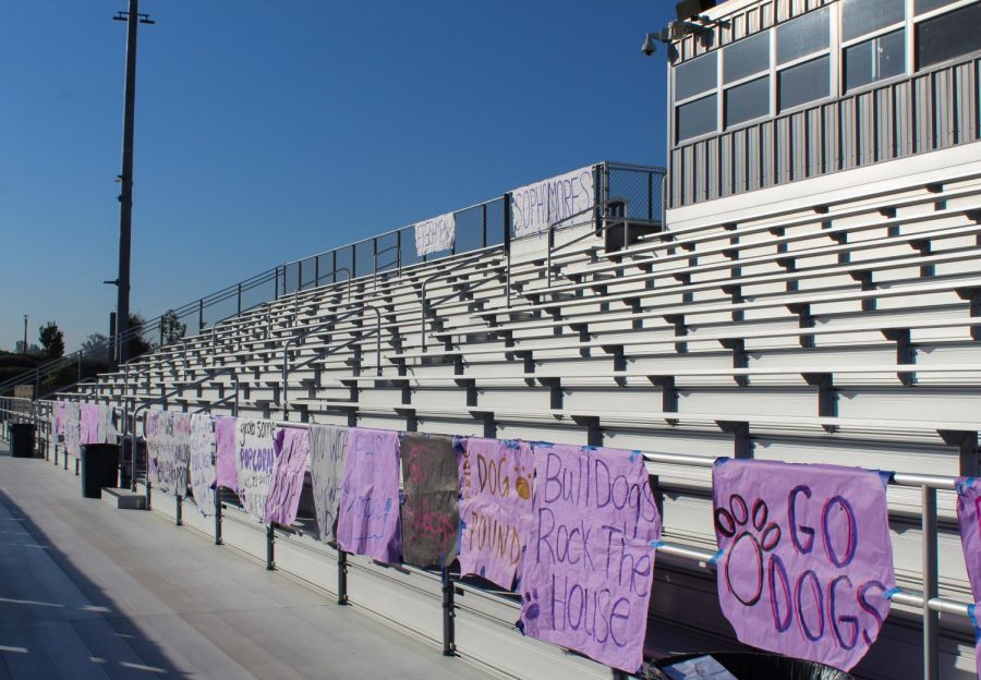 Before the rally has begun, posters adorn the railings of the empty bleachers, which have already been subdivided into sections for freshmen, sophomores, juniors and seniors. In total, ASB created over 50 posters over the span of five days, according to varsity cheerleader, social media commissioner and senior Alexandra Moll ; phrases written on the posters included “bark bark bark bark bark” and “go dogs.”
